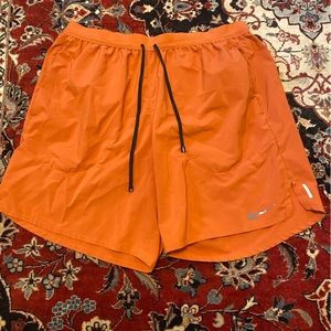 Nike Stride Shorts - size L - orange - with built in compression shorts.